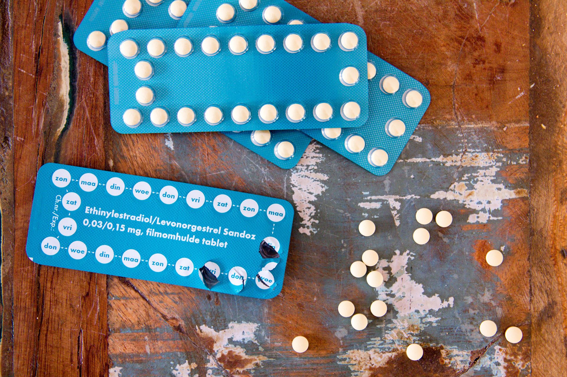 a picture of pills on a wooden table